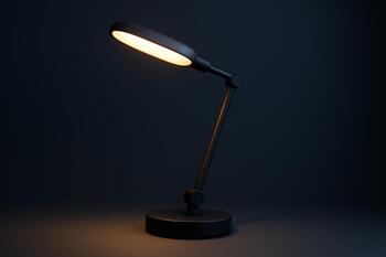 LED desk lamp casting warm light on notebook